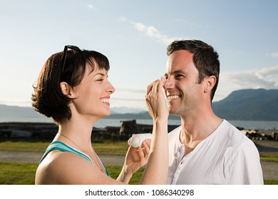 Couple Applying Suntan Lotion