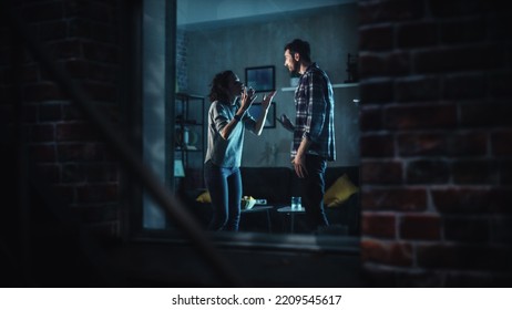 Couple Arguing and Fighting Violently. Domestic Violence and Emotional abuse Scene, Stressed Woman and Aggressive Man Screaming at Each other. Dramatic Scene. Shot Through Window Inside Apartment. - Shutterstock ID 2209545617