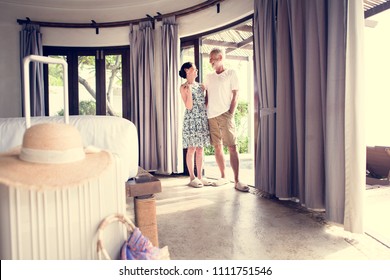 Couple Arriving To A New Hotel Room