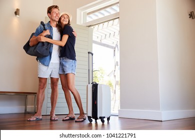 Couple Arriving At Summer Vacation Rental