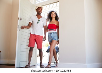 Couple Arriving At Summer Vacation Rental