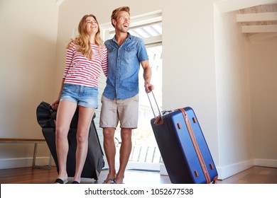 Couple Arriving At Summer Vacation Rental