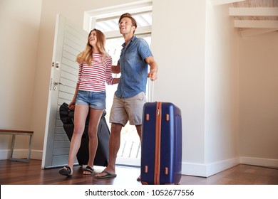 Couple Arriving At Summer Vacation Rental