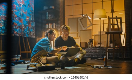 Couple Artists Sitting in their Studio Use Laptop Computer  Working Project  Talking   Smiling  Painter   Her Partner Doing Research  Authentic Workshop and Oil Paintings   Tools