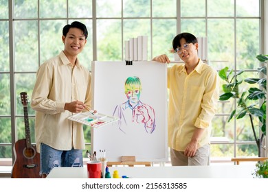 Couple Asian Gay Or Lgbt Man Stand Beside Of Painting That They Make Together In Room Of Their House With Happiness Also Look At Camera. 