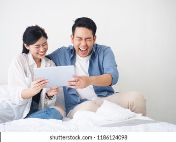 Couple Asian Lover Laughing Together At Living Room.