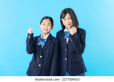 Couple of Asian schoolgirl fist pumping.