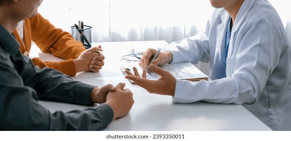 Couple attend fertility consultation with gynecologist at hospital as part family planning care for pregnancy. Loving husband and wife support each other through the doctor appointment. Panorama Rigid - Powered by Shutterstock