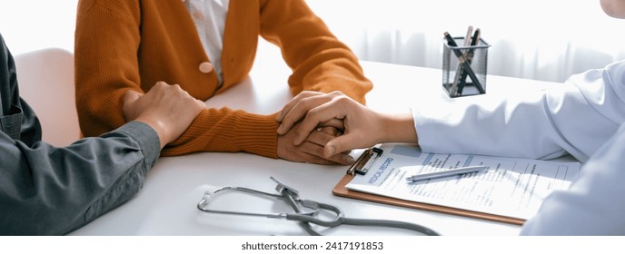 Couple attend fertility or medical consultation with gynecologist at hospital as family planning care for pregnancy. Husband and wife consoling each other through doctor appointment. Panorama Rigid - Powered by Shutterstock