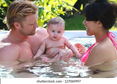 Couple And Baby Enjoy The Hot Tub