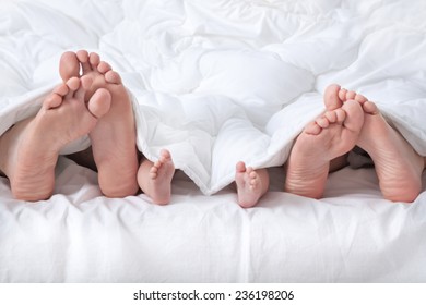 Couple With Baby Showing Foot