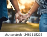 Couple, back and holding hands outdoor for love, relationship and date together with loyalty. Man, woman and commitment as romantic walking with trust, support and care in street for happiness