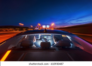 Couple In The Backseat Of An Airport Shuttle, Travelling In Luxury