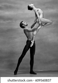 Couple Of Ballet Dancers Posing Over Gray Background