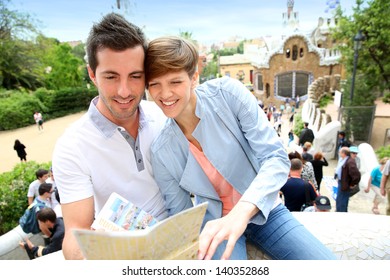 Couple In Barcelona Reading Travel Guide