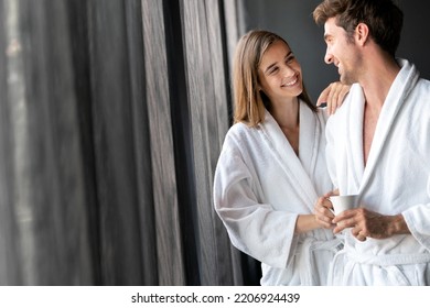 Couple In Bathrobes Enjoying Honeymoon In Spa Resort