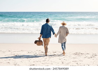 Couple, beach and holding hands in walking, back and holiday for vacation, ocean and adventure. Romantic, summer and picnic basket in bali, bonding and sea or outdoor, mockup and romance on sand - Powered by Shutterstock