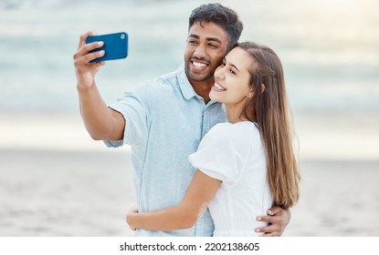 Couple, Beach Selfie And Smile For Happy Travel Fun, Freedom Day And Relaxing Summer Vacation Outdoors. Photos And Young People Celebrate With Love Hug On Holiday, Romance Together And Honeymoon Date