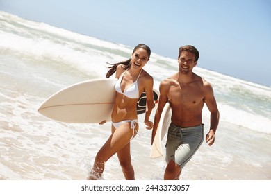 Couple, beach and surfboard for surfing or portrait with happiness, adventure and fitness with blue sky. Man, woman and surfer by ocean in the morning for holiday, vacation and freedom with swimwear - Powered by Shutterstock