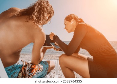 Couple Beach Tablet - Man and woman using tablet on beach during sunny day. - Powered by Shutterstock