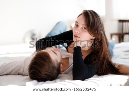 Similar – Image, Stock Photo Young couple in love embracing lying over a bed