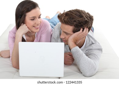 Couple in bed with computer