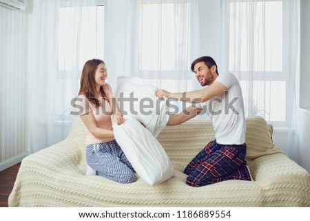 Similar – Image, Stock Photo Man showing baby clothes to pregnant woman