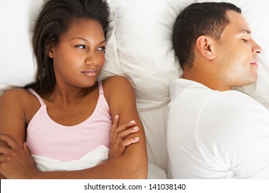 Couple In Bed With Relationship Difficulties