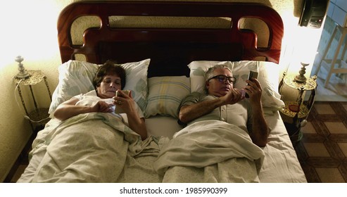 Couple in bed using smartphone - Powered by Shutterstock