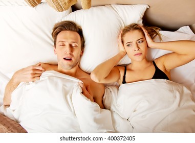 Couple In Bed,man Snoring Woman Can't Sleep