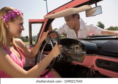 Couple Being Silly In Old Fashioned Convertible Car