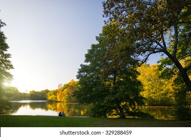 Couple In A Berlin Park Enjoying Autumn Sunset