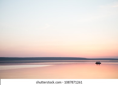 Couple in a boat in a lake or pond or river in a sunset calm water no wind summer minimalism silhouette people beautiful meditation tourism outdoor meditation life happiness - Powered by Shutterstock