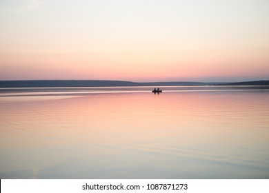 Couple in a boat in a lake or pond or river in a sunset calm water no wind summer minimalism silhouette people beautiful meditation tourism outdoor meditation life happiness - Powered by Shutterstock