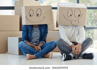 Couple, box and face emoji in new house for comedy, funny and happiness for dream home. Homeowner, man and woman in relationship with cardboard for relocation, property investment and smile drawing - Powered by Shutterstock