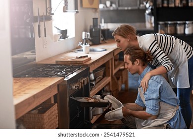 Couple, bread and oven with baking tray in kitchen for home made wheat, snack or meal together. Man, woman or bakers with recipe, mini loaf or sourdough for cooking creation, breakfast or morning - Powered by Shutterstock