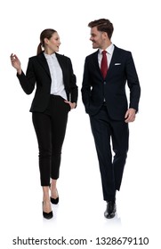 Couple In Business Suits Walking And Talking While Looking At Each Other On White Background