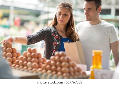 Couple buying fresh eggs at farmer's food market
 - Powered by Shutterstock