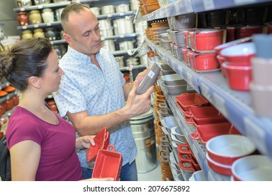 Couple Buying Kitchenware In A Store