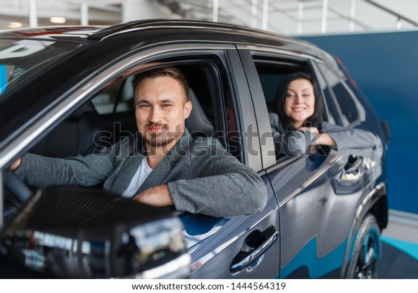 Couple buying\
new car, departure from the\
salon