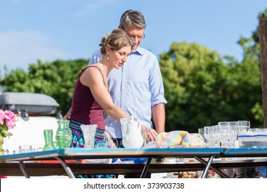 Couple Buying Stuff At Flea Market