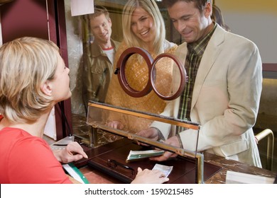 Couple Buying Tickets At Box Office