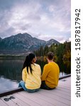 couple by the lake watching sunset, Pyramid lake Jasper during autumn in Alberta Canada, fall colors by the lake during sunset, Pyramid Island Jasper