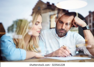 Couple At Cafe Reading Bank Contract Document