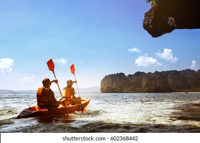 Couple Canoeing Or Kayaking At Sea Island Backdrop. Krabi Province, Thailand. Space For Text