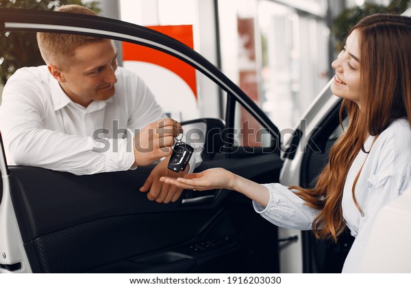 Couple in a car salon. Family buying the car.
Elegant woman in a white
blouse
