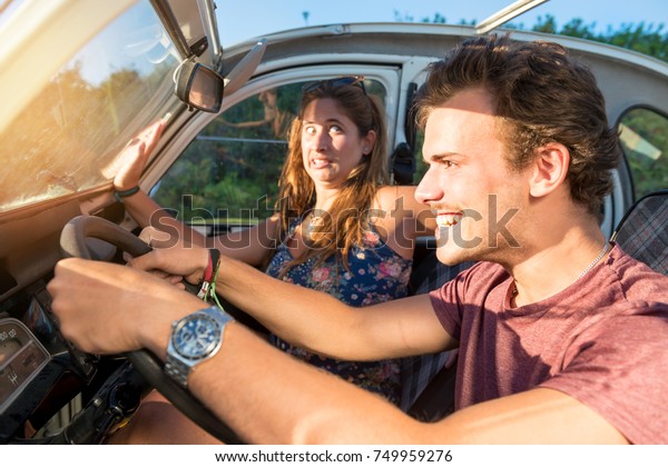Couple in a car at sunset, with\
male driving fast and girl scared, screaming and\
praying.