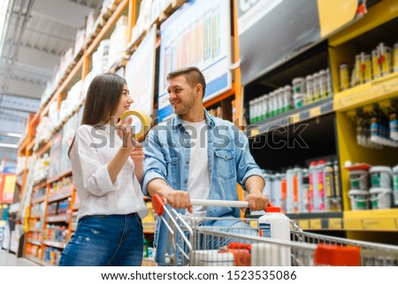 Couple with a cart buying building materials