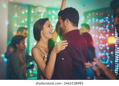 Couple, celebrate and dance in club at night on date with love in marriage or relationship. People, hug and embrace together with happiness at neon disco, party or rave at techno music festival - Powered by Shutterstock