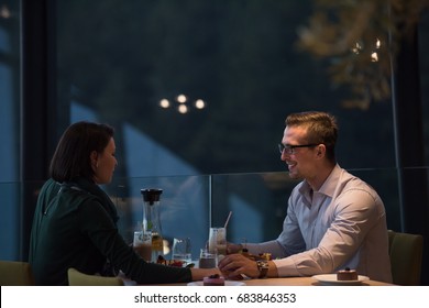 Couple Celebrate Valentine's Day With Romantic Dinner In Restaurant Near The Window